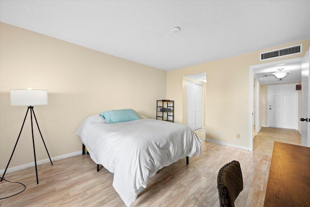 bedroom featuring light hardwood / wood-style flooring and a closet