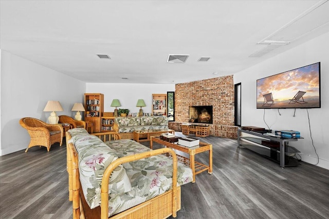 living room with dark hardwood / wood-style flooring and a fireplace