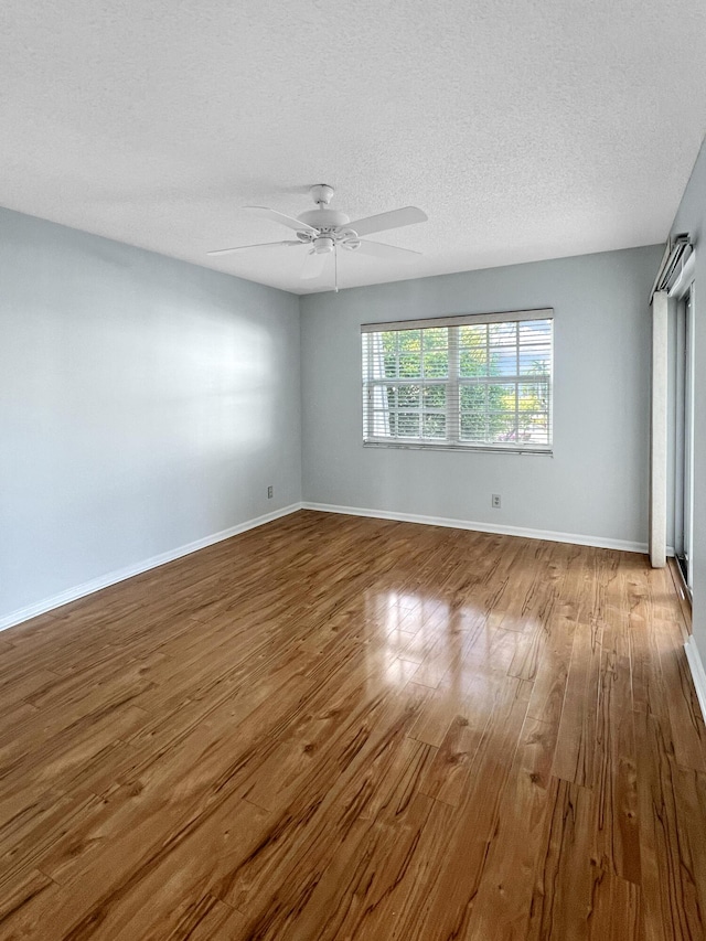 spare room featuring ceiling fan, a textured ceiling, and light hardwood / wood-style flooring