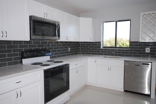 kitchen with white cabinets, appliances with stainless steel finishes, backsplash, and sink