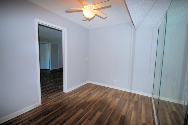 spare room featuring dark hardwood / wood-style flooring and ceiling fan