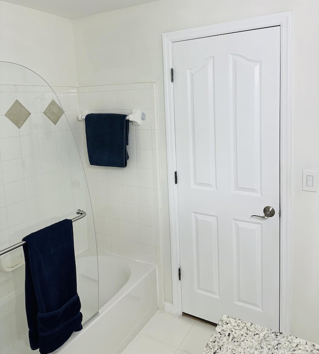 bathroom featuring a washtub and tile patterned floors