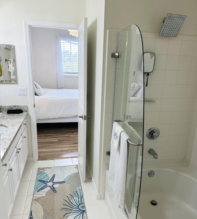 bathroom featuring tile patterned floors, vanity, and tiled shower / bath combo