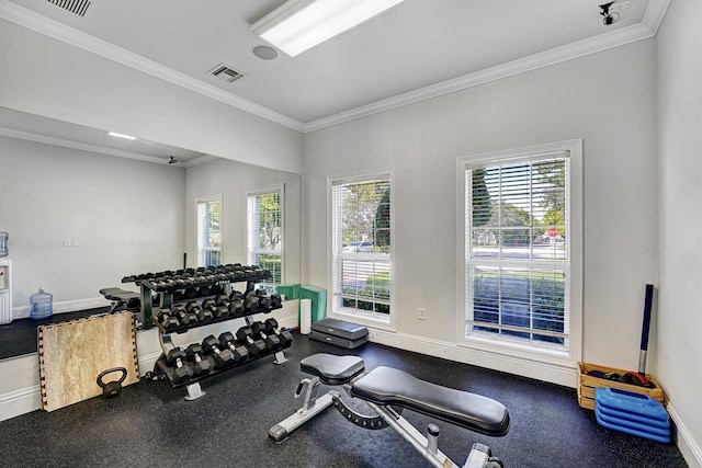 workout room featuring crown molding