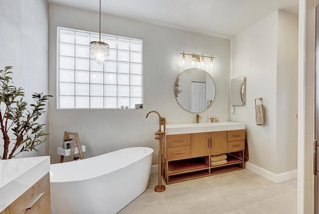 bathroom with tile patterned flooring, vanity, and a bathing tub