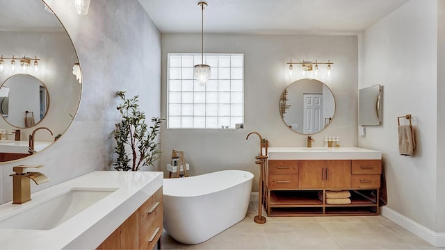 bathroom featuring tile patterned floors, a washtub, and vanity