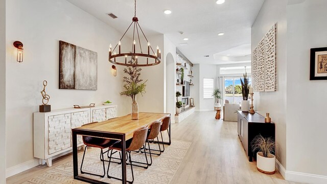 dining area featuring a chandelier and light hardwood / wood-style floors