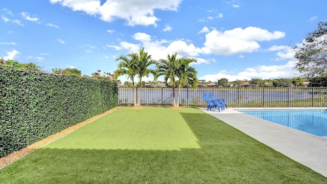 view of yard featuring a water view, a patio area, and a fenced in pool