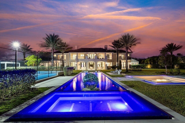 view of pool at dusk