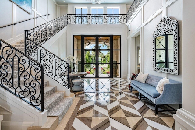 entryway with parquet floors and a high ceiling