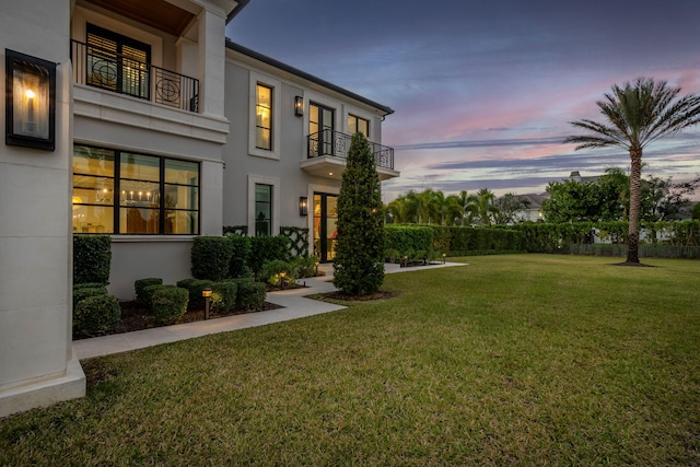 yard at dusk with a balcony