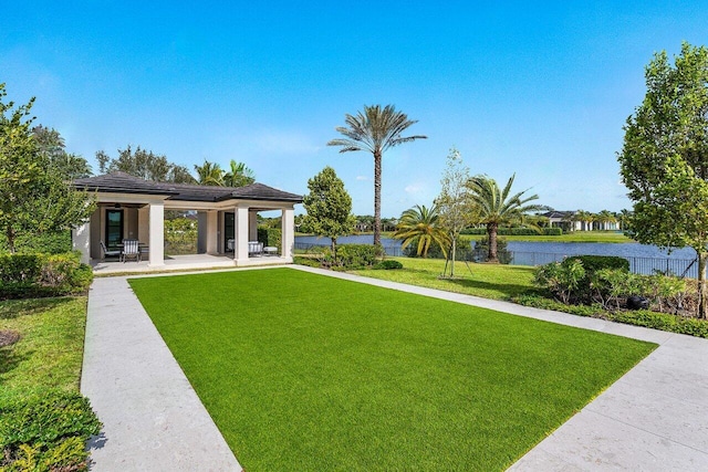 view of yard with a water view and a patio area