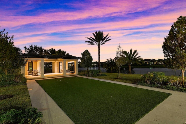 yard at dusk with covered porch