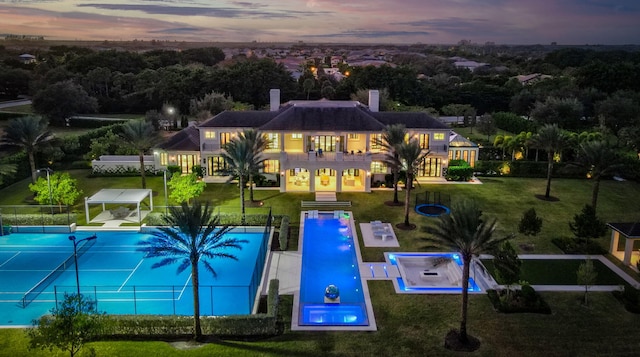 view of pool at dusk