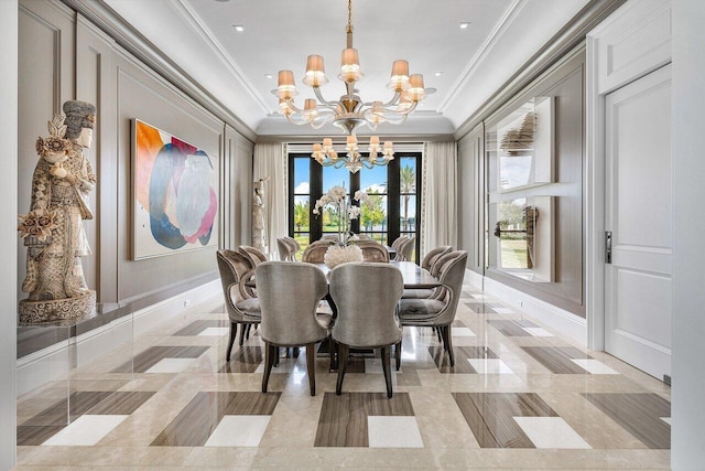 dining space with ornamental molding and a chandelier