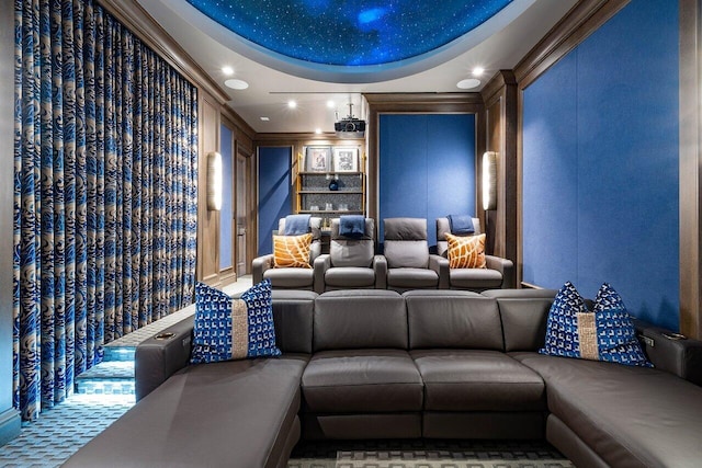 home theater with a raised ceiling and crown molding