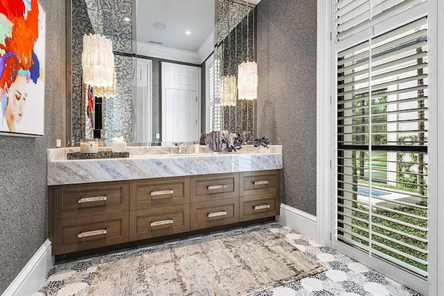 bathroom featuring ornamental molding and vanity