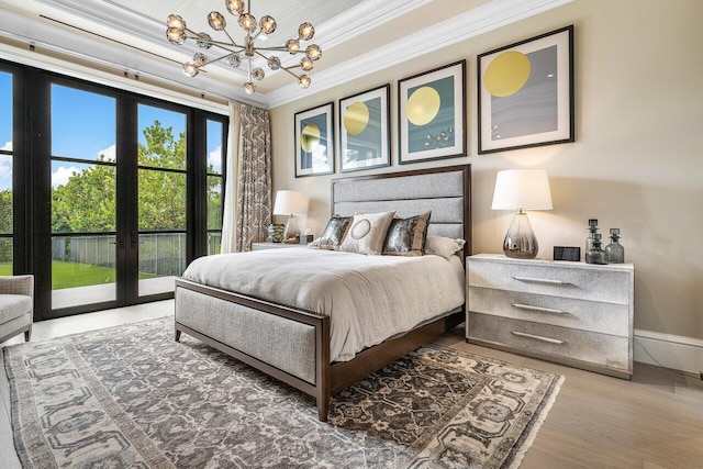 bedroom featuring crown molding, hardwood / wood-style flooring, an inviting chandelier, access to outside, and french doors