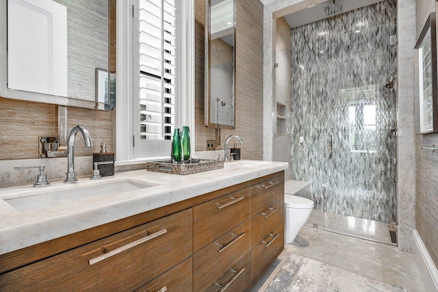 bathroom with tile walls, vanity, toilet, and walk in shower