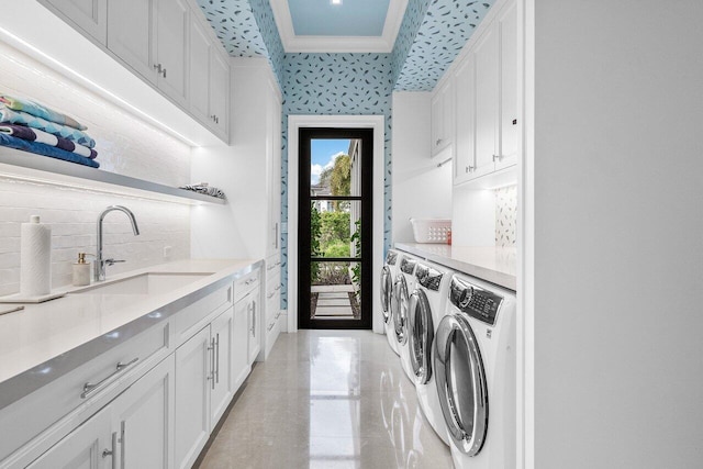 16071 Quiet Vista Cir, Delray Beach, FL 33446 - washroom featuring crown molding, a sink, washer and dryer, wallpapered walls, and cabinet space