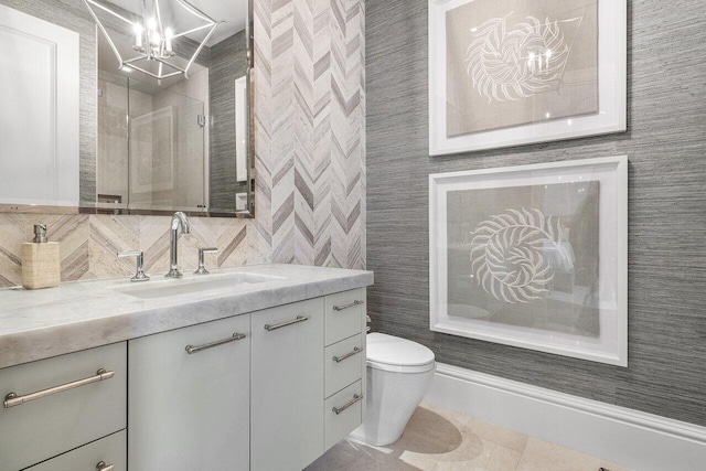 16071 Quiet Vista Cir, Delray Beach, FL 33446 - full bathroom with an inviting chandelier, toilet, a shower stall, vanity, and tile patterned floors