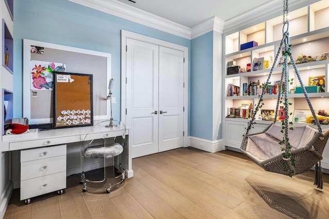 home office featuring built in features, ornamental molding, and light wood-type flooring