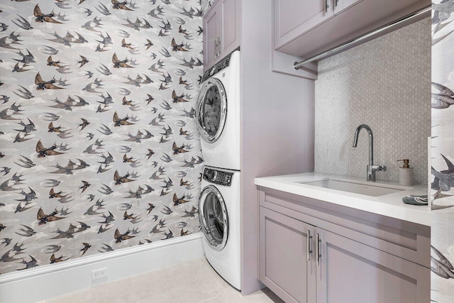 16071 Quiet Vista Cir, Delray Beach, FL 33446 - washroom with a sink, cabinet space, stacked washer and dryer, and wallpapered walls