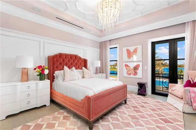 bedroom with french doors, coffered ceiling, an inviting chandelier, access to outside, and ornamental molding