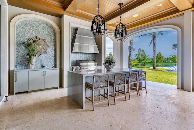 view of patio / terrace featuring area for grilling, grilling area, and a wet bar