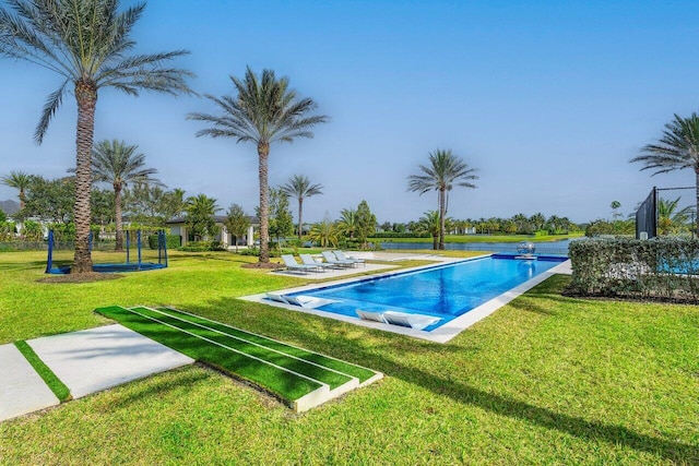 view of pool featuring a lawn