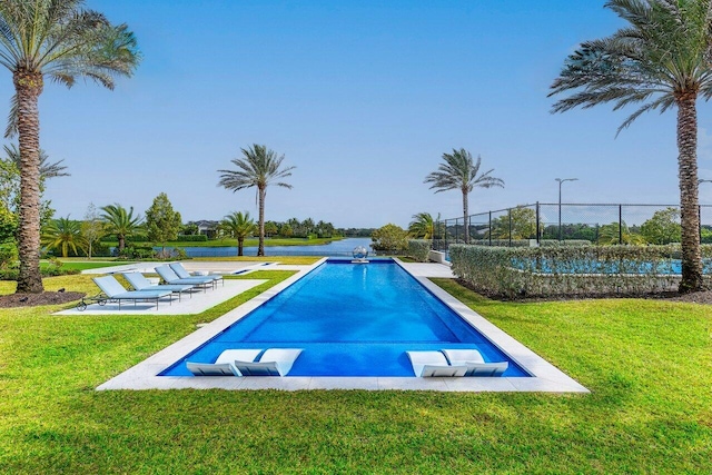 view of pool featuring a lawn