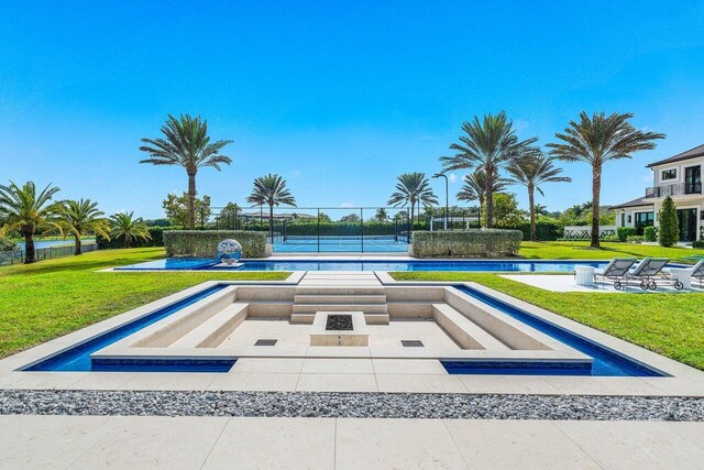 view of swimming pool featuring a water view and a lawn