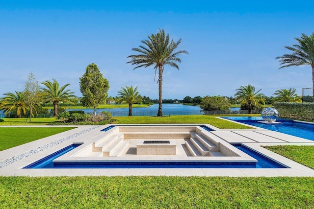 view of swimming pool with a water view and a yard