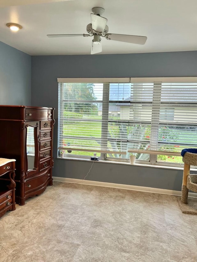 interior space with ceiling fan