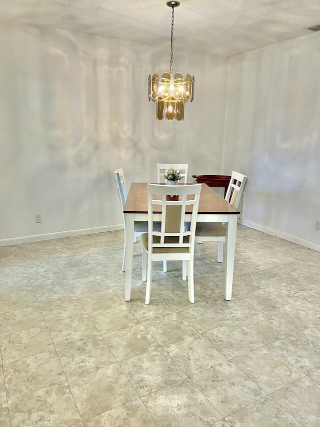 dining room with a notable chandelier and a textured ceiling