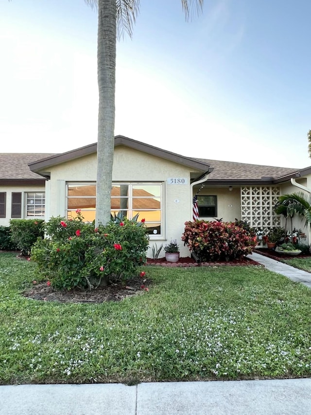 view of side of property with a yard