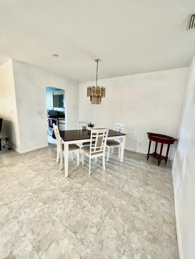 dining room featuring a notable chandelier