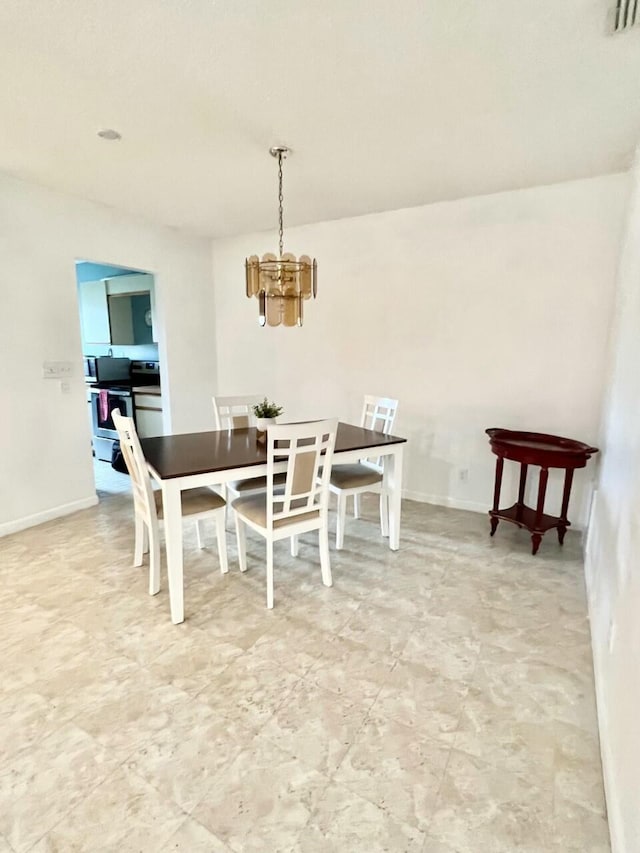 dining area featuring a notable chandelier