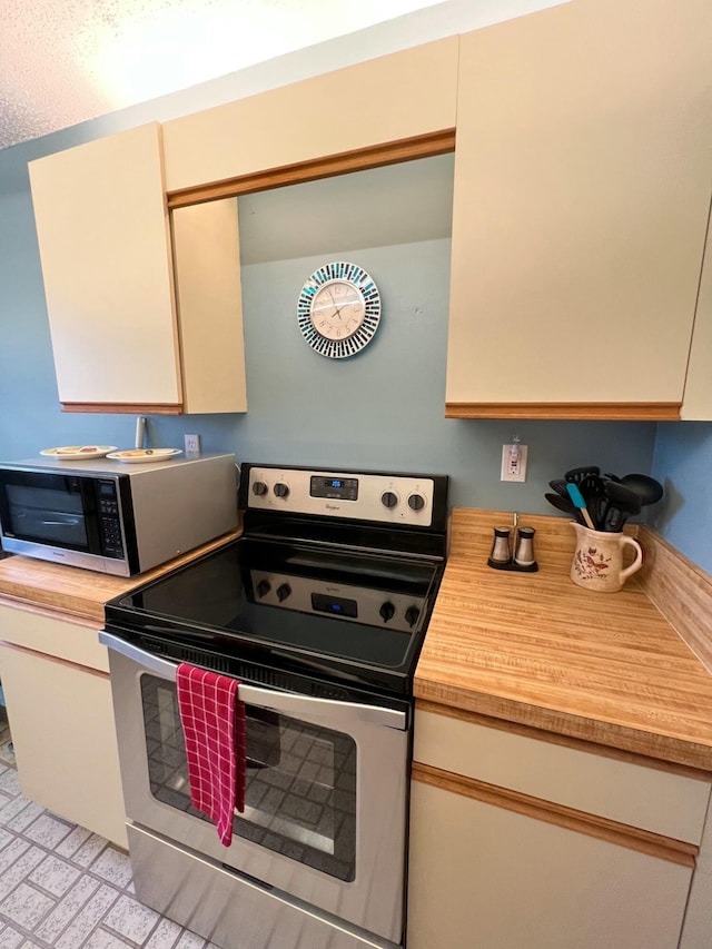 kitchen with wood counters and stainless steel appliances