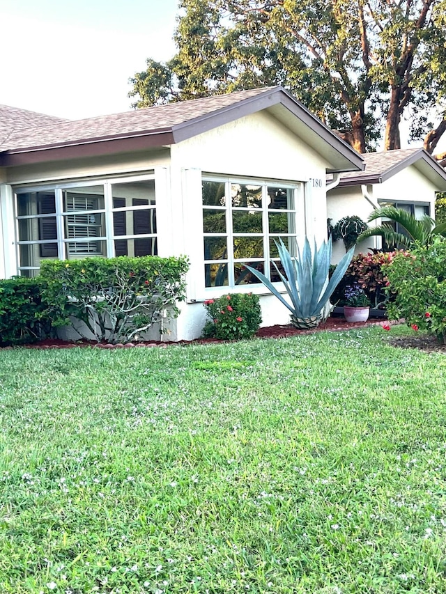 view of property exterior with a yard