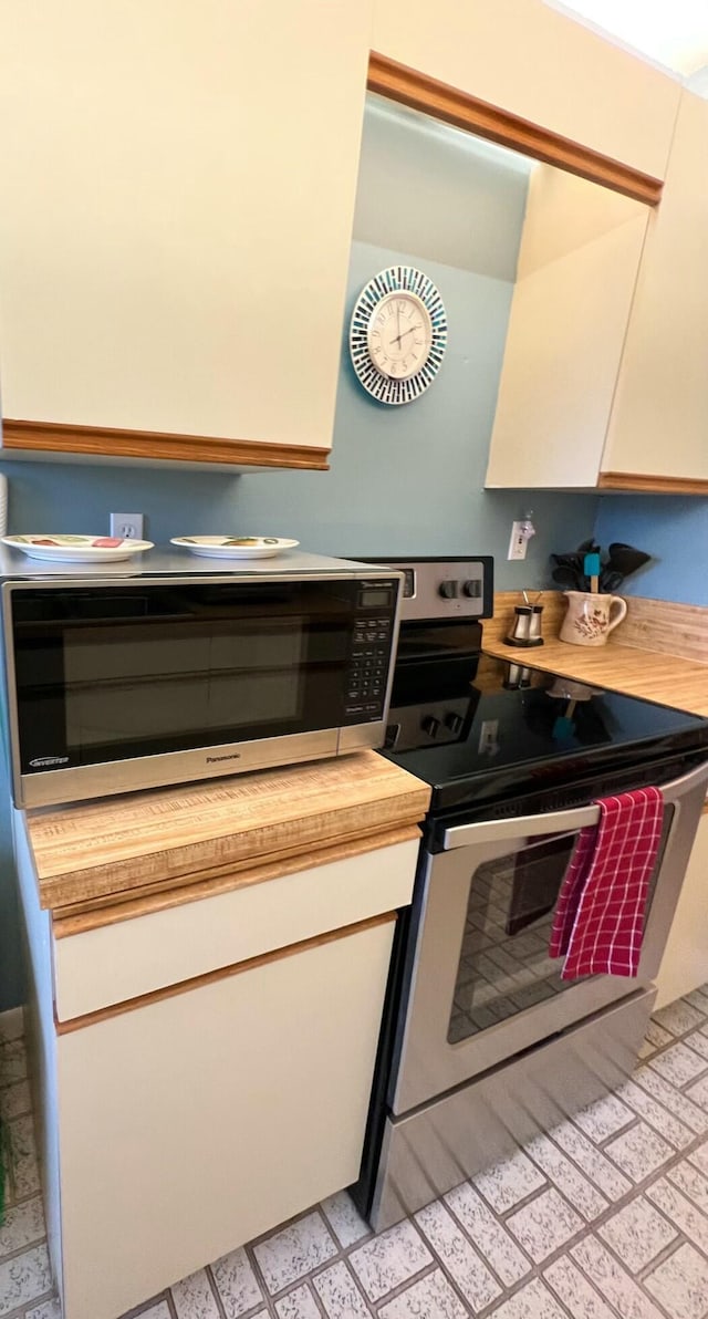 kitchen with butcher block counters and stainless steel appliances