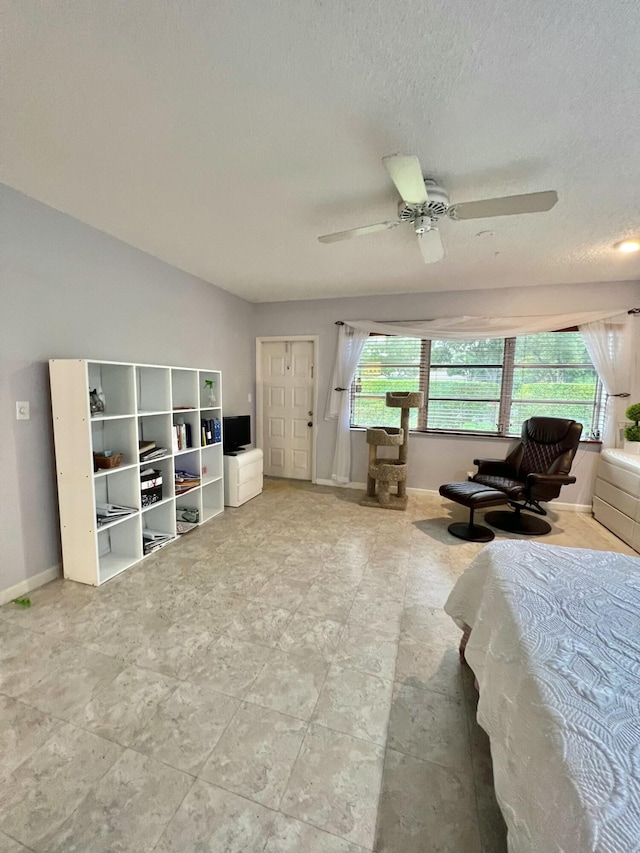 bedroom with a textured ceiling, multiple windows, ceiling fan, and lofted ceiling