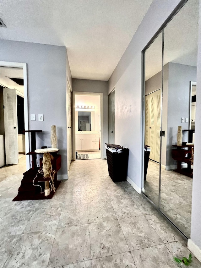 hallway with a textured ceiling