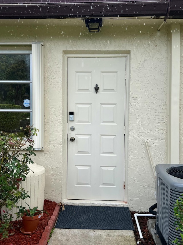 doorway to property featuring central AC