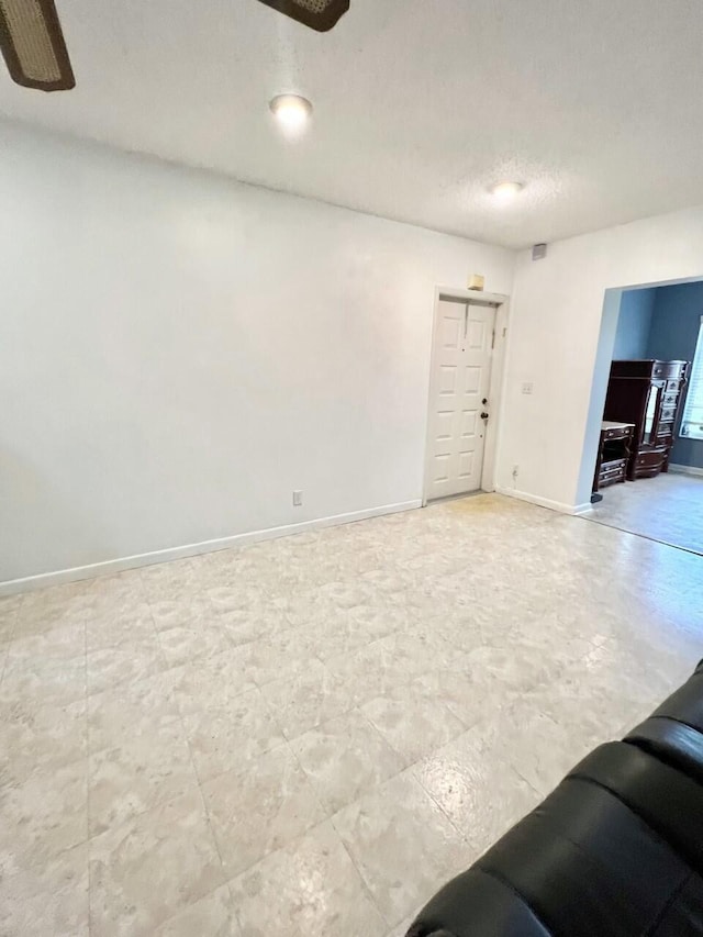 unfurnished living room featuring a textured ceiling