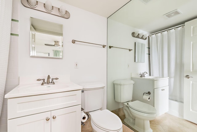 full bathroom with tile patterned floors, vanity, shower / tub combo, and toilet