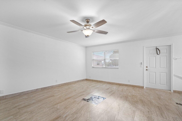 unfurnished room featuring ceiling fan and ornamental molding