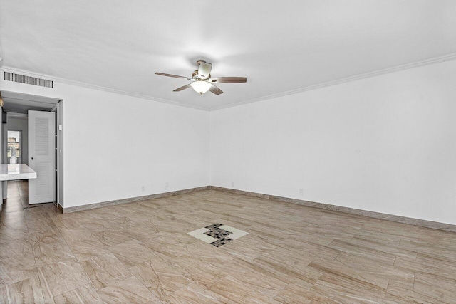 spare room with ceiling fan and ornamental molding