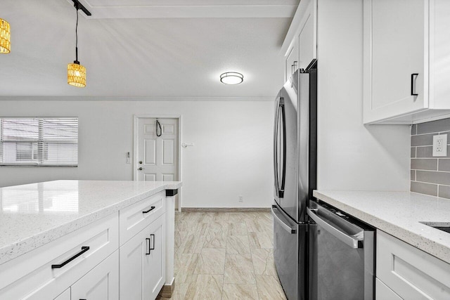 kitchen with white cabinets, appliances with stainless steel finishes, light stone countertops, and hanging light fixtures