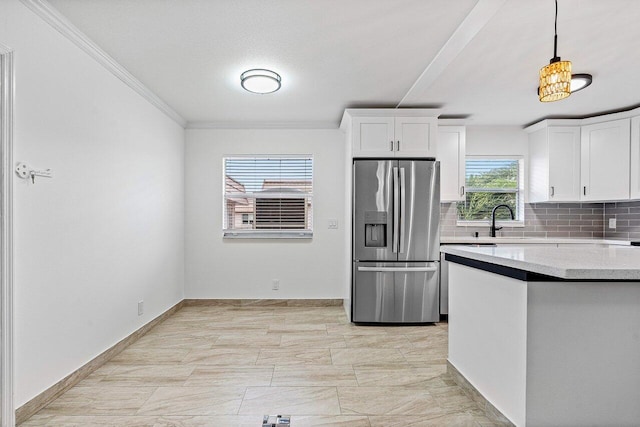 kitchen featuring tasteful backsplash, crown molding, stainless steel fridge with ice dispenser, white cabinetry, and hanging light fixtures